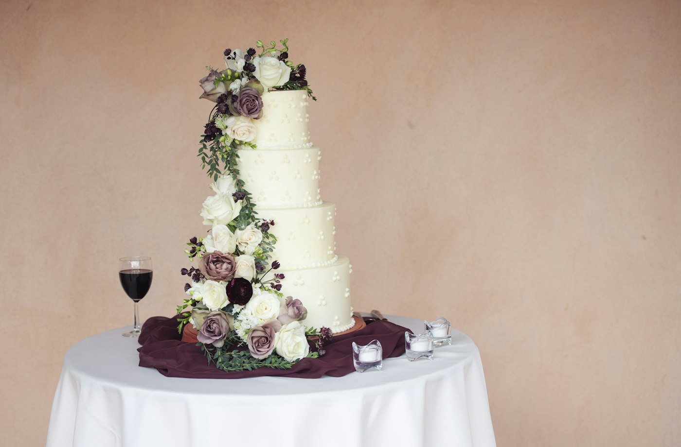 Tiered buttercream celebration cake finished with fresh florals