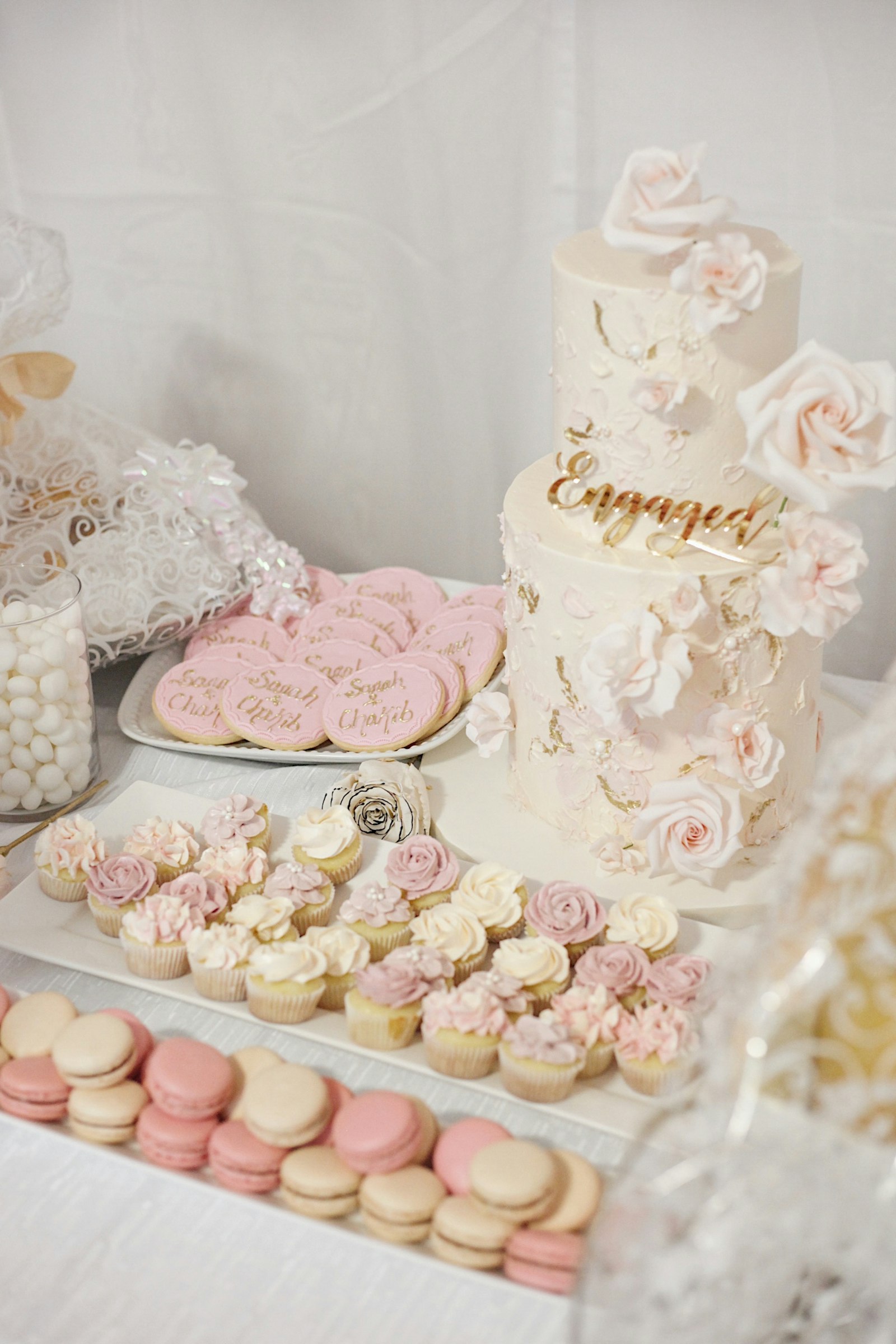Wedding dessert table with cake, cupcakes and small sweets