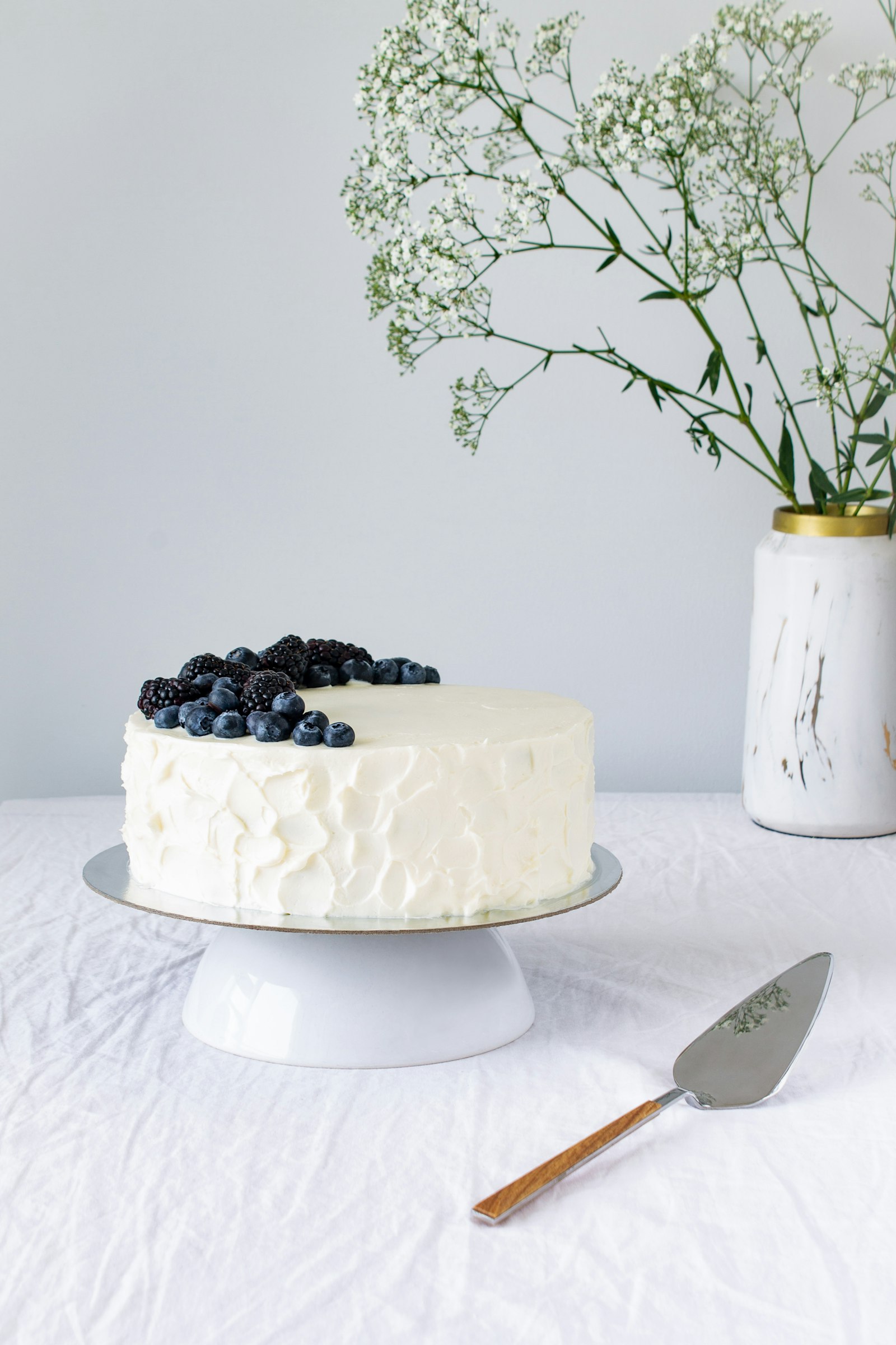 Minimalist white tiered wedding cake by Baker's Blvd for a Duluth, Georgia wedding