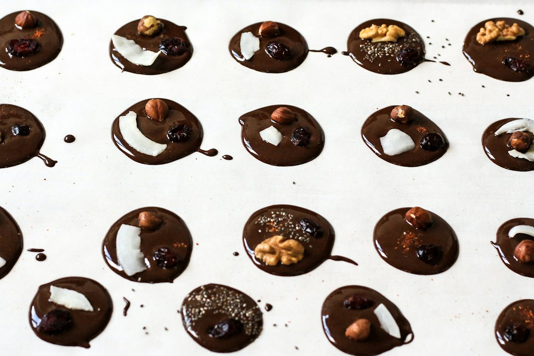 Chocolate nut clusters setting on parchment